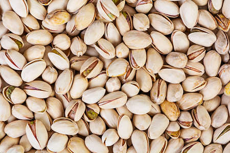 Background of pistachio nuts. Roasted salted pistachios.