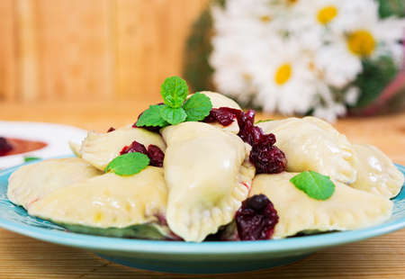 Delicious dumplings with cherry on wooden backgroundの写真素材