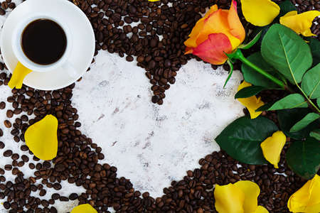 Cup of coffe and rose on a white background. Top viewの写真素材