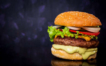 Delicious handmade burger on dark background. Close viewの写真素材