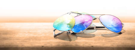 Summer vacation concept. Sunglasses with ocean beach and palms.の写真素材