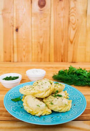 Delicious dumplings with cabbage on wooden backgroundの写真素材