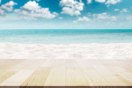 Empty wooden table top on Beautiful white sand beach and Blur Beautiful Cloud on Blue sky at Seaの写真素材