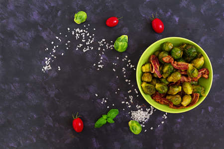 Roasted brussels sprouts with bacon on dark background. Top viewの写真素材