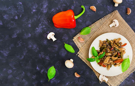 Stir Fry Chicken with peppers and peas on dark background. Top viewの写真素材