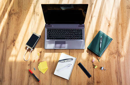 Workplace with notebook laptop at home. Workplace at pandemic coronavirus quarantine concept.の写真素材