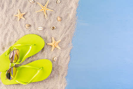 Summer background. Sea sand with seashells, starfish and sunglasses. Summer vacation conceptの写真素材