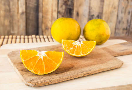 Close up sliced orange on wooden table backgroundの写真素材
