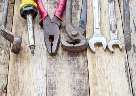 Close up bunch of used tools on wooden table backgroundの写真素材