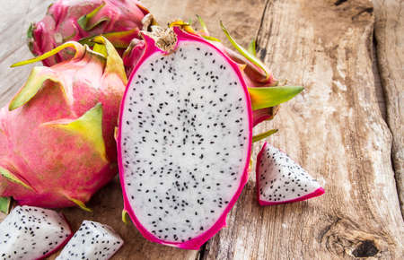 Fresh dragon fruit on wooden table backgroundの写真素材