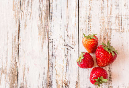 Fresh strawberries on white wooden table background - Top viewの写真素材