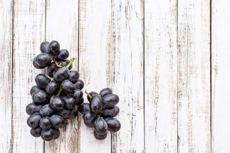 Grapes on white wooden table background. top viewの写真素材