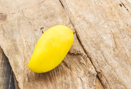 Close up ripe mango on a wooden floorの写真素材