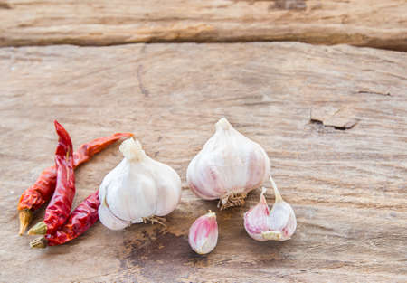 Garlic and dry chili on wooden table backgroundの写真素材