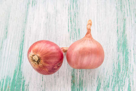 Fresh organic red onion on wooden backgroundの写真素材
