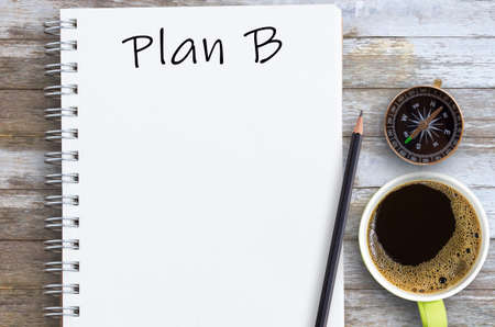Plan B written on notebook with pencil and cup of coffee with copy space. Concept for change of planの写真素材