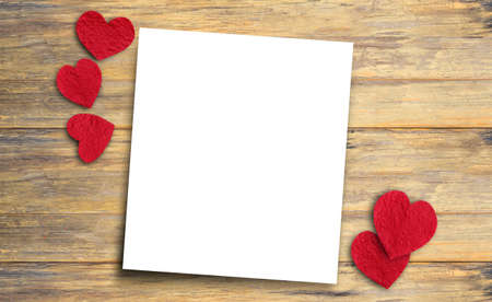 Red paper heart and paper on wood table. Top view with copy space for design.の写真素材