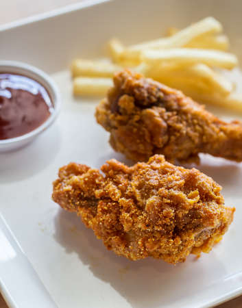 Delicious, roasted chicken legs on a white Plateの写真素材