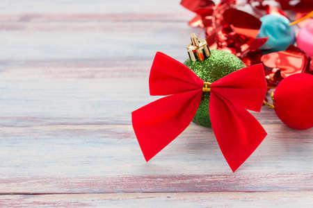 Red ribbon and christmas decoration on old grunge wooden table background.space for desing. christmas and new year concept.の写真素材