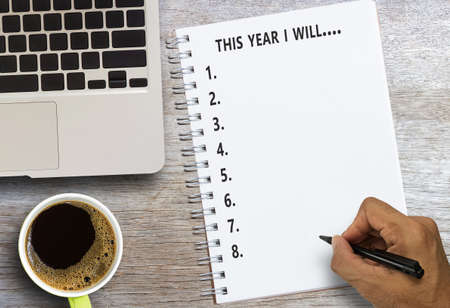 Top view handwriting text writing this year i will with laptop computer and coffee cup on wooden...