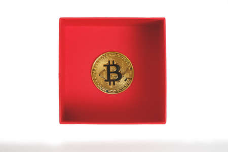 Bitcoin coin in a red gift box on a white background.Mining gift for Valentine Dayの写真素材
