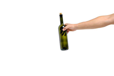 Empty, green, glass wine bottle in hand on a white background, isolateの写真素材