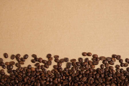 Coffee beans on a cardboard background, copy spaceの写真素材