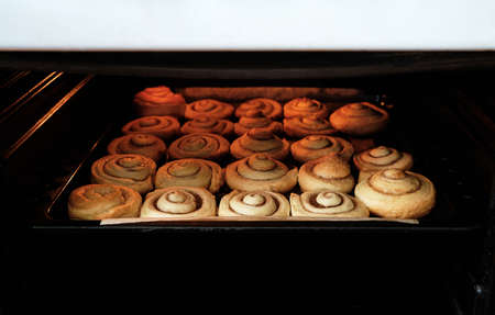Cinnamon rolls are baked in oven, homemade cakesの写真素材