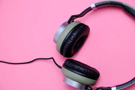 Wired headphones in khaki on a pink backgroundの写真素材