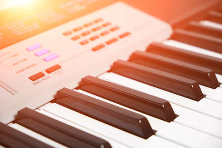 Keys and control panel of a music synthesizer with bright sunlightの写真素材