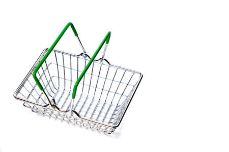 Metal shopping basket with green handles on white backgroundの写真素材