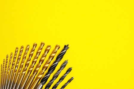 Set of drills for wood and metal on a yellow backgroundの写真素材