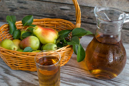 Pears in the basket and pear juice in a bottle on wooden backgroundの写真素材