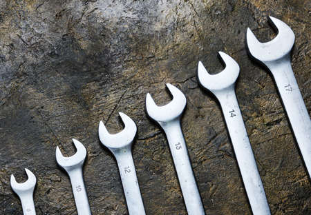 Set of wrenches on a concrete background