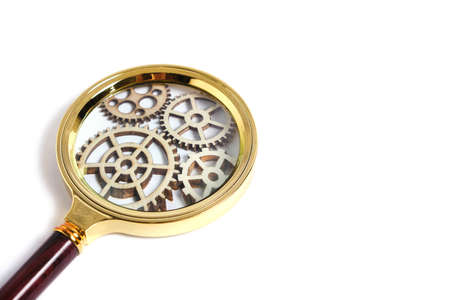 Magnifier with gears on a white background.The concept of learning progressの写真素材