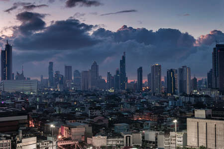 Bangkok city with high buildings in downtown and dramatic sky at dawnの写真素材