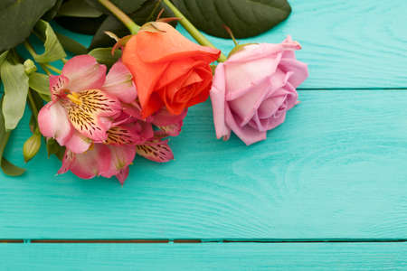 Bouquet of flowers on blue wooden background. top view and copy space.の写真素材