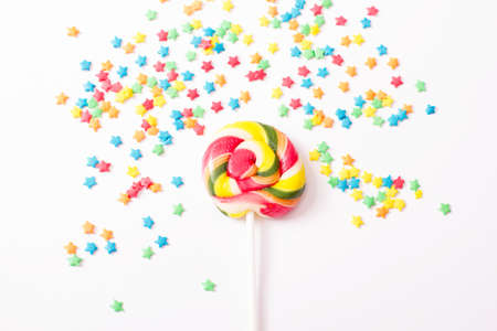 Colorful candy, lollipop and sweets isolated on white background. Top view. Selective focus.の写真素材