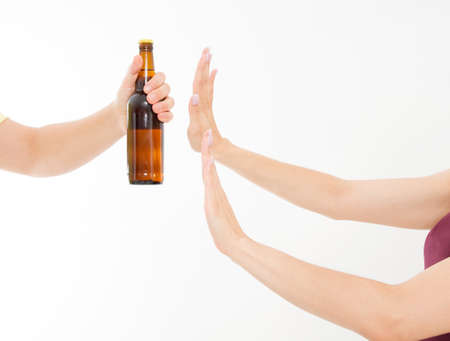 female hand reject a bottle of beer isolated on white background.anti alcohol concept. Copy spaceの写真素材