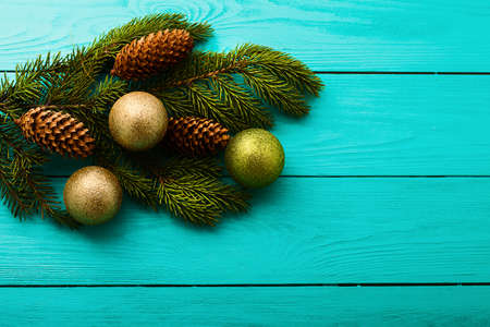 Frame of pine cones on a Christmas tree on blue wooden background. Top view and copy spaceの写真素材