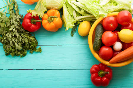 Macro vegetables with copy space on blue wooden table. Top viewの写真素材