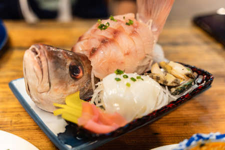 Raw sashimi of sea bass fillet, fresh squid and shell  on ceramic plateの写真素材