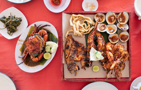 Seafood set with lobster, crab, fish, shrimp, shellfish on wooden tray in bali restaurantの写真素材