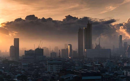 Sunrise over Bangkok city with high buildings in downtown and dramatic sky at Thailand