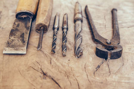 Old construction tools on a wooden workbench flat lay background. Carpenter table. Woodwork.の写真素材