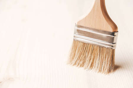 Paint brushes with a wooden handle and natural bristles on a wooden background. Repair concept. Copy, empty space for text.の写真素材