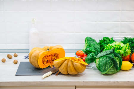 Organic raw vegetables. Sliced fresh vegetables with pumpkin. On rustic background .の写真素材