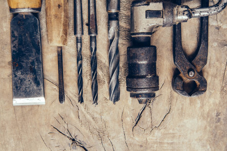 Old construction tools on a wooden workbench flat lay background. Carpenter table. Woodwork.の写真素材