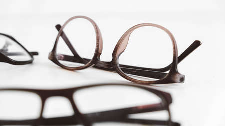 Three optical glasses of different shapes on a white background.