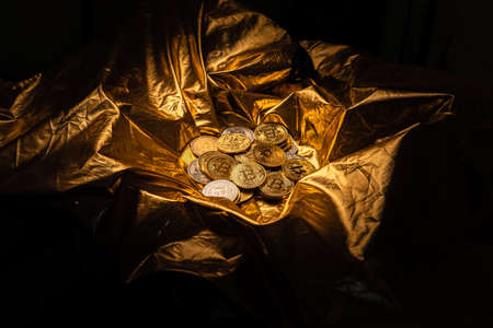 crypto coin and bitcoin on golden background,gold mining backgroundの写真素材